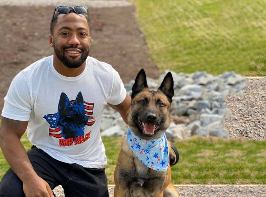 A happy puppy sitting attentively while being trained with treats, showcasing positive reinforcement techniques for effective puppy training classes.
